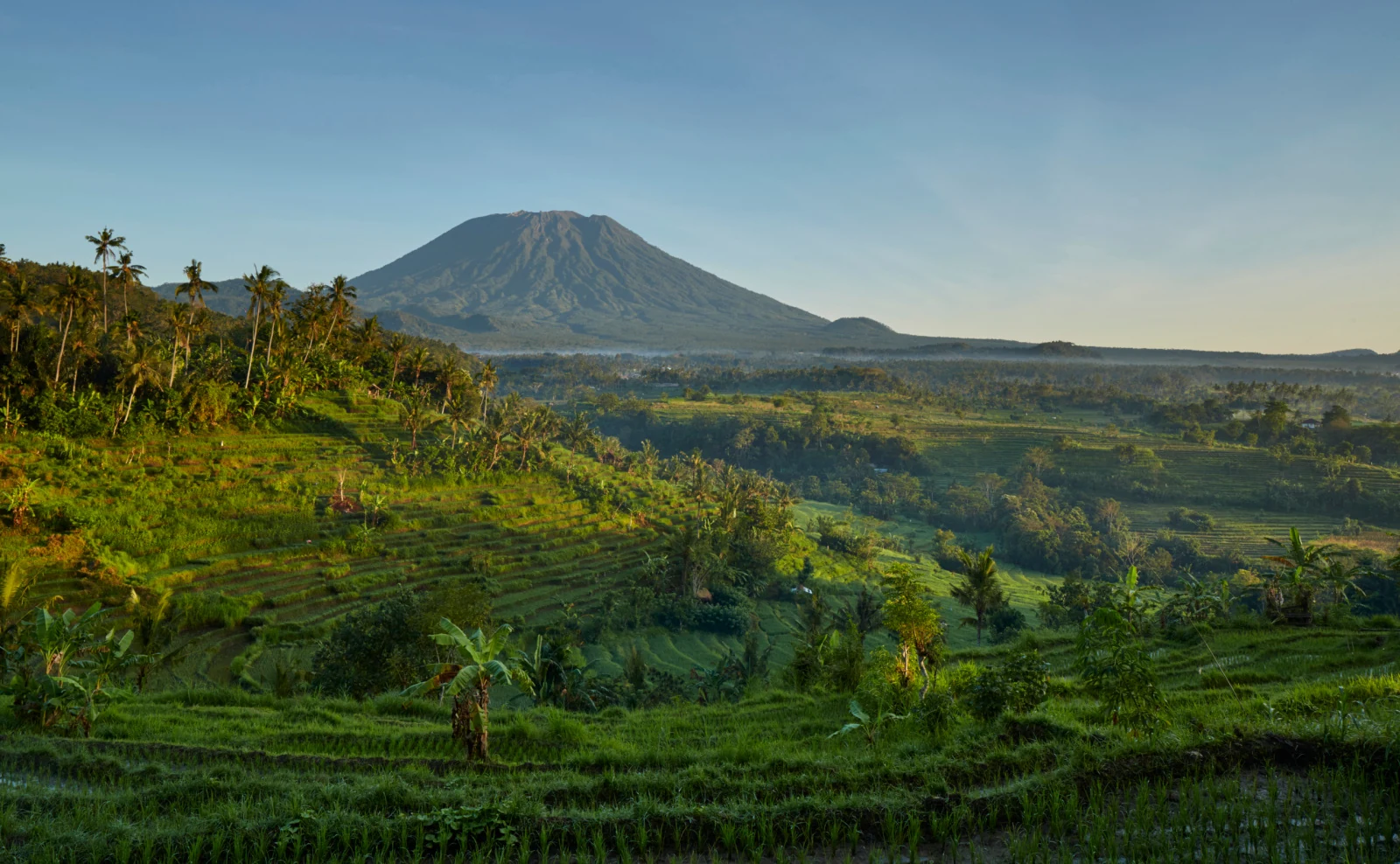 Mount Agung above terraced green fields in East Bali.