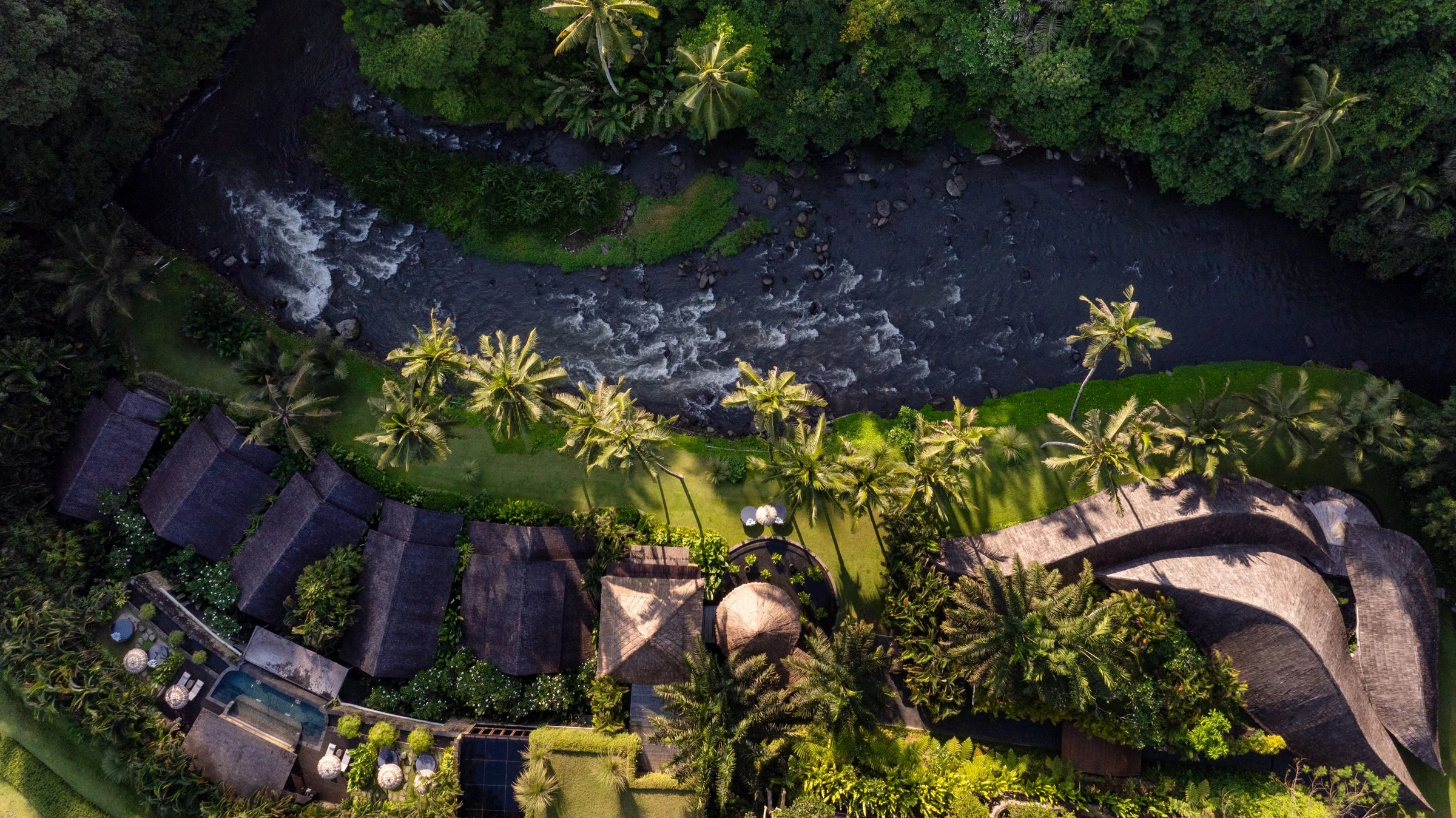 An aerial view of Mandapa’s spa pavilions beside the Ayung River.