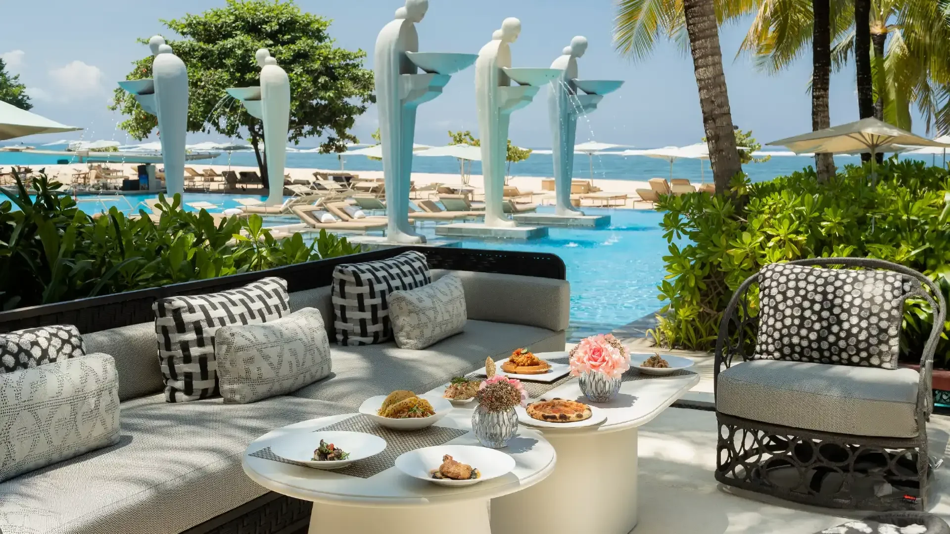 Soleil’s outdoor dining setting with plated dishes and views toward the ocean.
