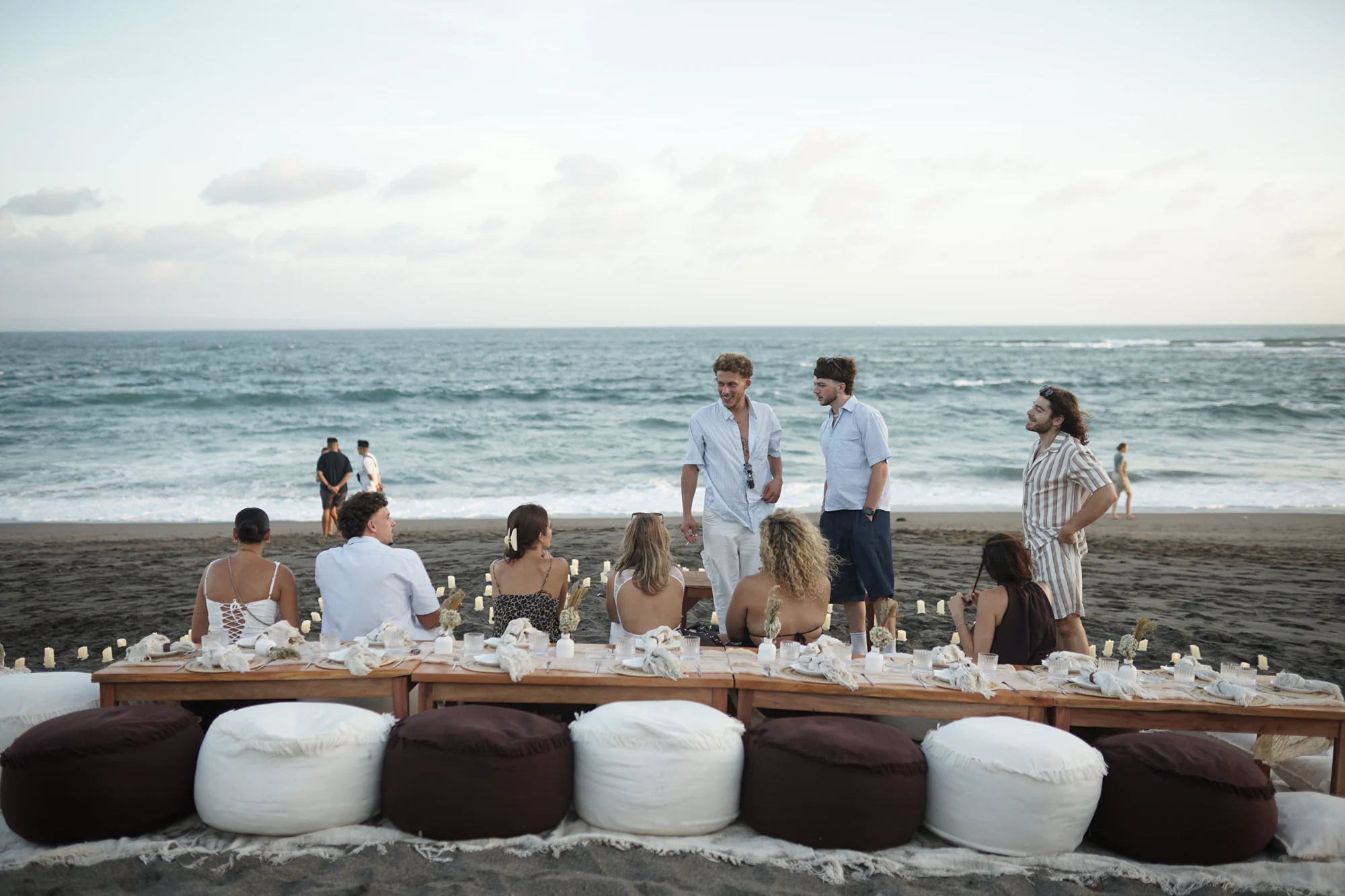 Guests enjoy a privately arranged Firefly picnic beside the sea in Bali.