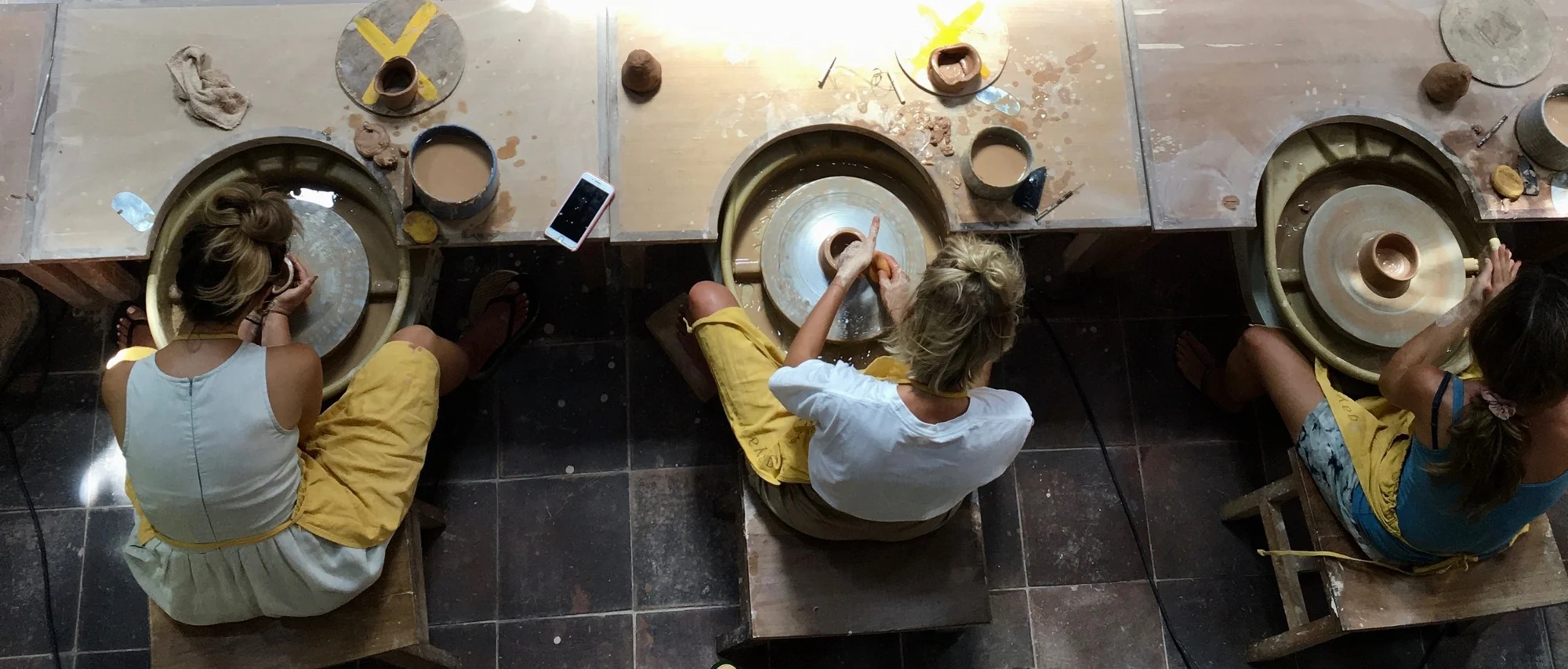 Students explore clay at pottery wheels inside Gaya Ceramic Arts Center.