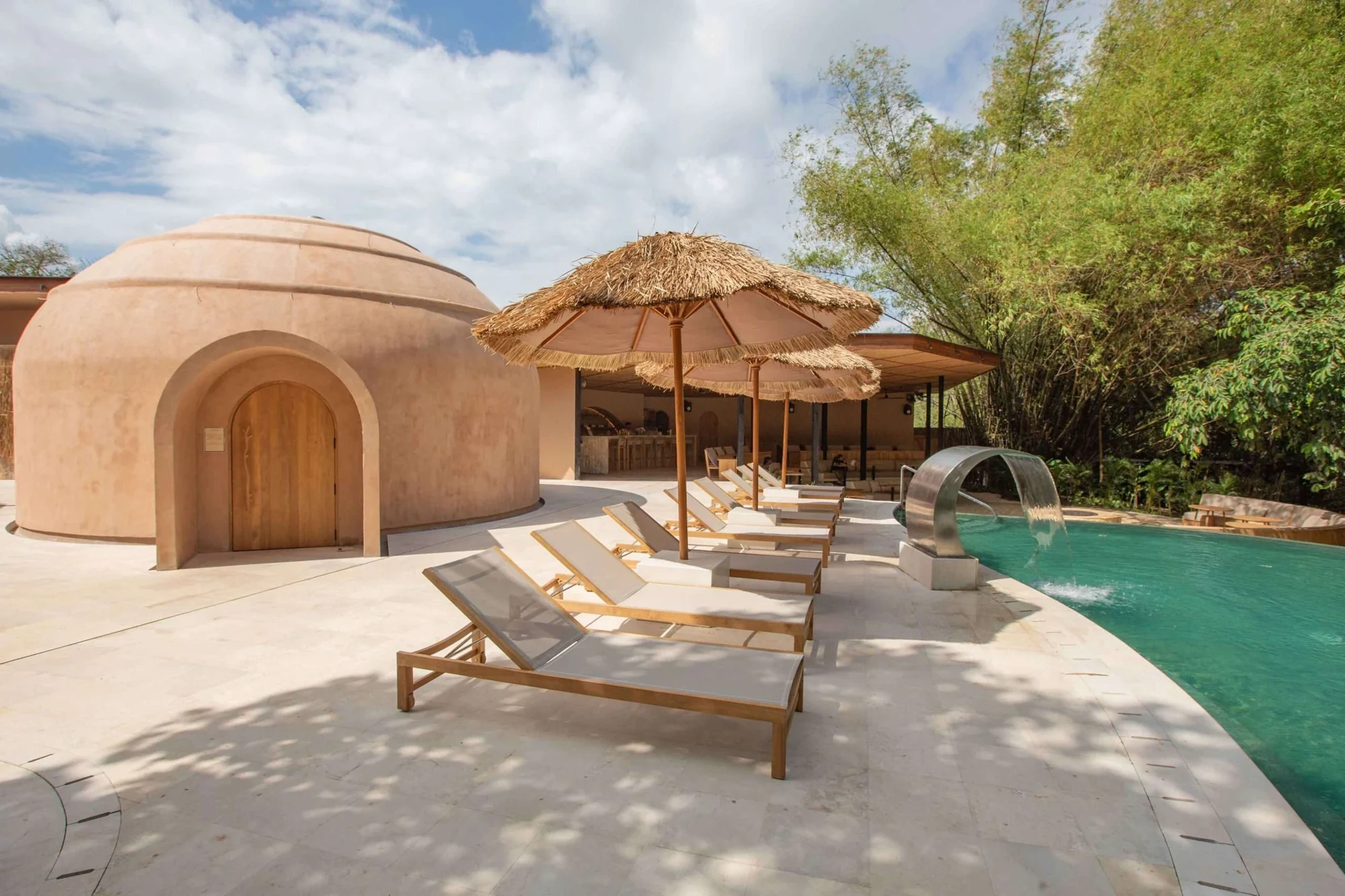 Lumeira’s rounded steam dome and timber sauna beside its outdoor pool and sun loungers.