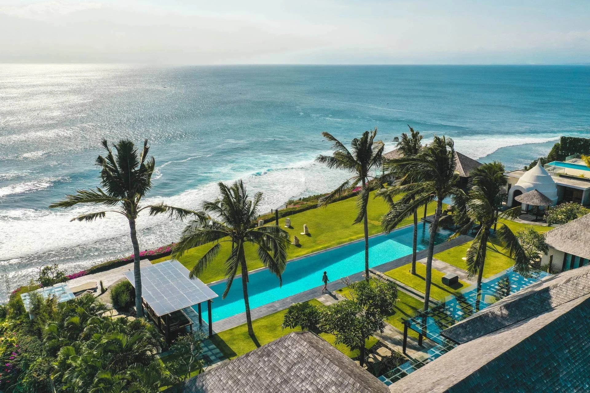 The Istana’s long infinity pool and palm-lined cliffside terrace above the Indian Ocean.