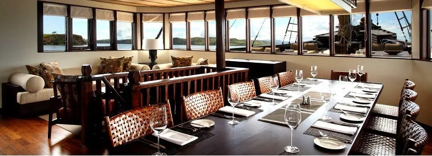 Alila Purnama dining salon with a long table and panoramic windows