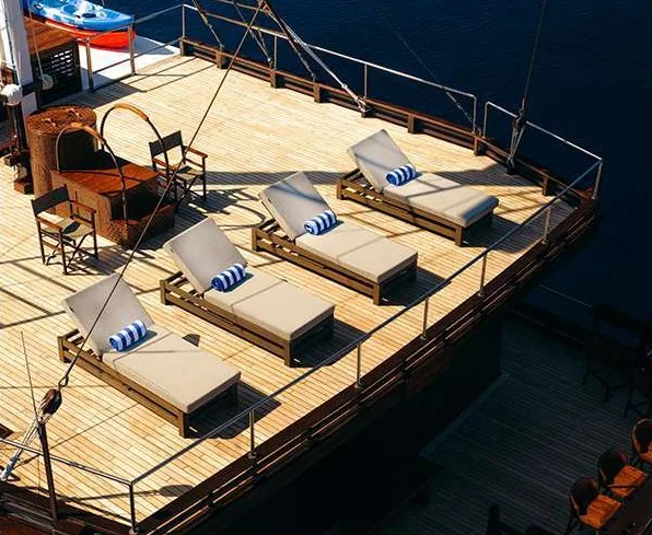 Bhavana timber sun deck with loungers and cream cushions