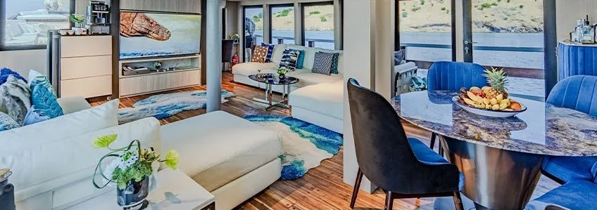 Kayra lounge with panoramic windows and blue and neutral seating