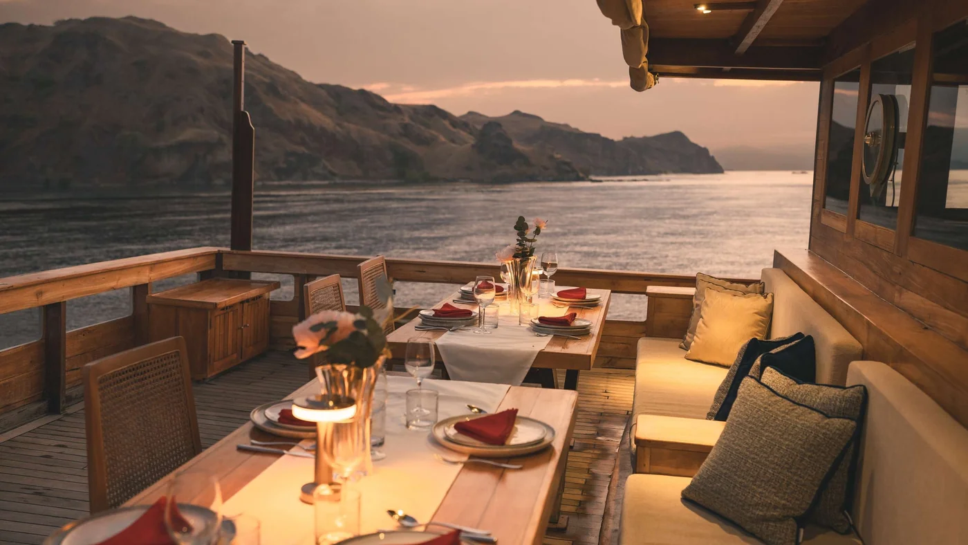 Mischief open-air dining deck overlooking a sheltered bay