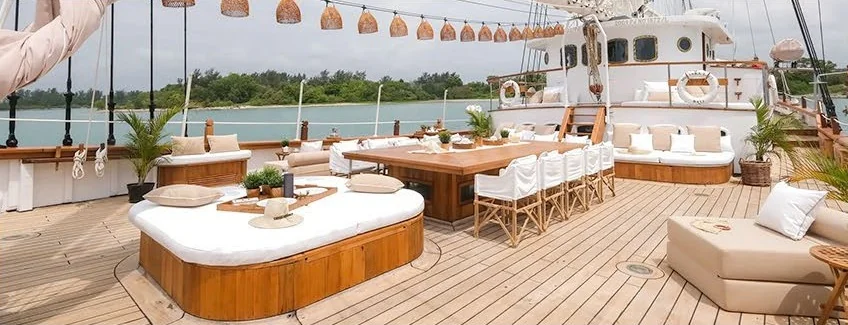 Mutiara Laut open deck lounge with wicker chairs and white cushions