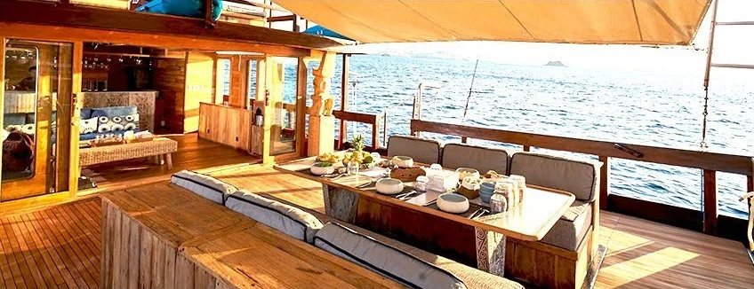 Oracle covered timber deck lounge beside the water