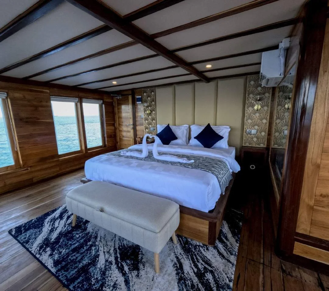 Raffles double cabin with timber finishes and sea-view windows