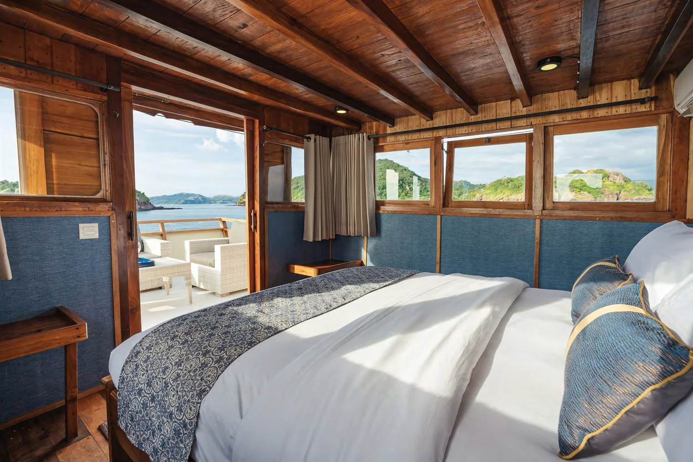 Samara I double cabin with blue upholstery and large sea-view windows