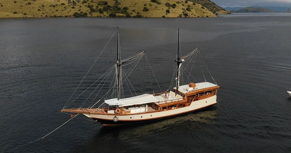 Samara II at anchor with its wooden decks and twin masts visible