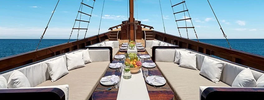 Samsara Samudra foredeck dining area with white-cushioned seating