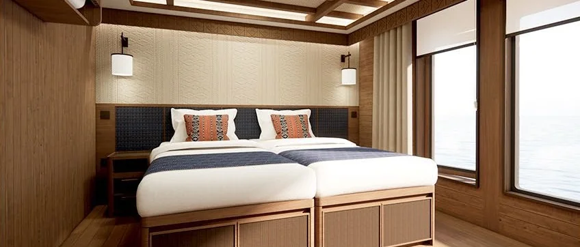 Design preview of Serenity double cabin with pale timber finishes and navy bedding