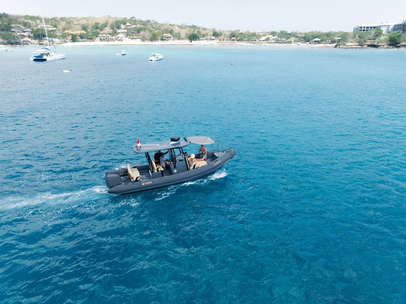 Typhoon motorboat on blue water near the coast